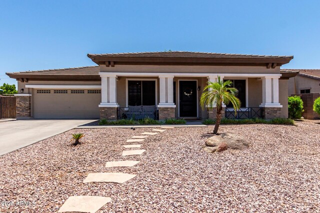465 E Frances Ln, Gilbert, AZ 85295 - view of front of house with concrete driveway, a garage, a porch, stucco siding, and a tile roof