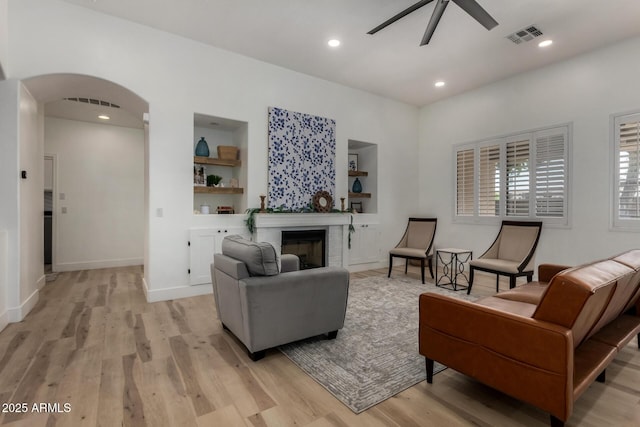 465 E Frances Ln, Gilbert, AZ 85295 - living area with ceiling fan, light wood-type flooring, arched walkways, a fireplace, and recessed lighting