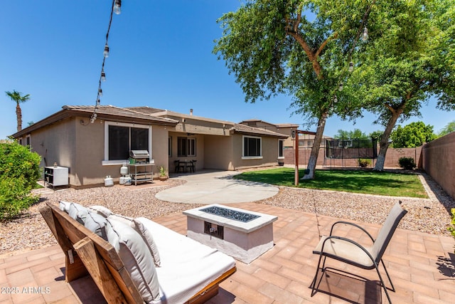 465 E Frances Ln, Gilbert, AZ 85295 - rear view of house with stucco siding, a patio area, a fenced backyard, and an outdoor living space with a fire pit