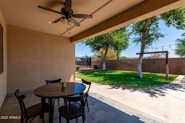 465 E Frances Ln, Gilbert, AZ 85295 - fenced backyard with a trampoline, a patio, a ceiling fan, and outdoor dining space