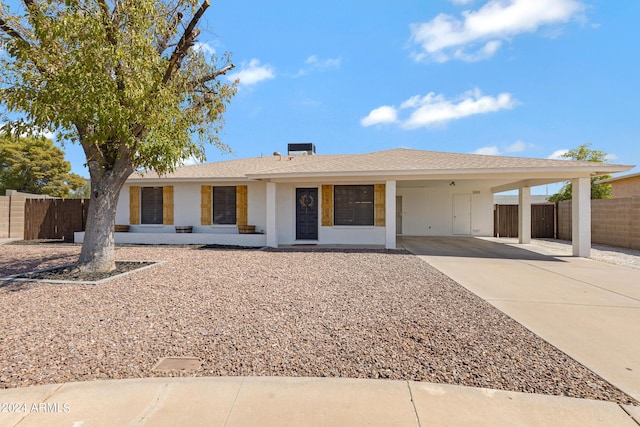 single story home featuring a carport