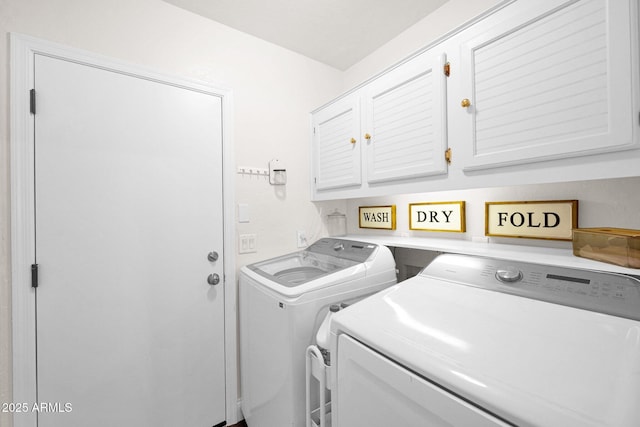 laundry room with washing machine and clothes dryer and cabinet space
