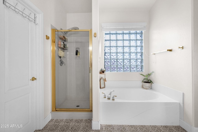 full bathroom featuring a shower stall and a bath