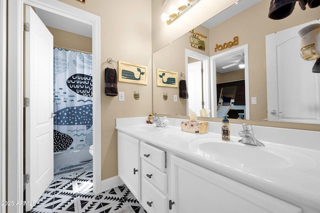 bathroom featuring toilet, a sink, ceiling fan, double vanity, and curtained shower