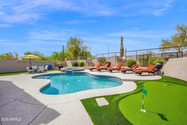 view of swimming pool with a fenced backyard, a pool with connected hot tub, and a patio