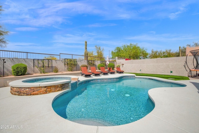 view of pool with a fenced backyard, a pool with connected hot tub, and a patio area