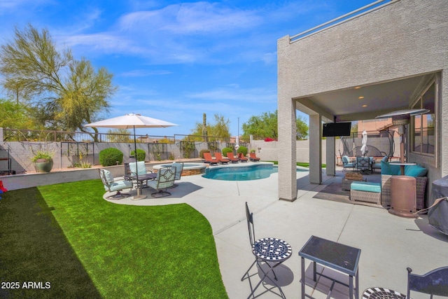 view of swimming pool featuring a pool with connected hot tub, a patio area, a fenced backyard, an outdoor hangout area, and a yard