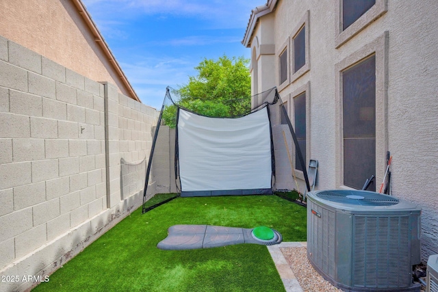 view of yard featuring central AC unit and a fenced backyard