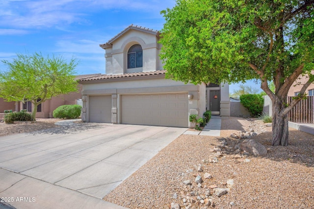 mediterranean / spanish-style house with a tile roof, a garage, driveway, and stucco siding