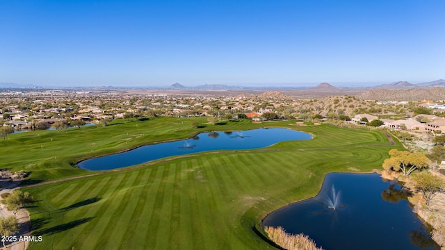 birds eye view of property featuring view of golf course and a water and mountain view