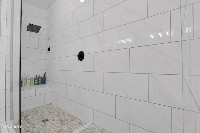 bathroom with a tile shower