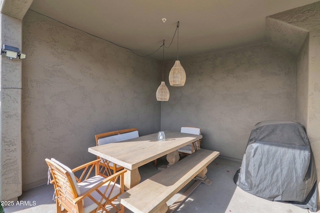 dining space featuring concrete floors