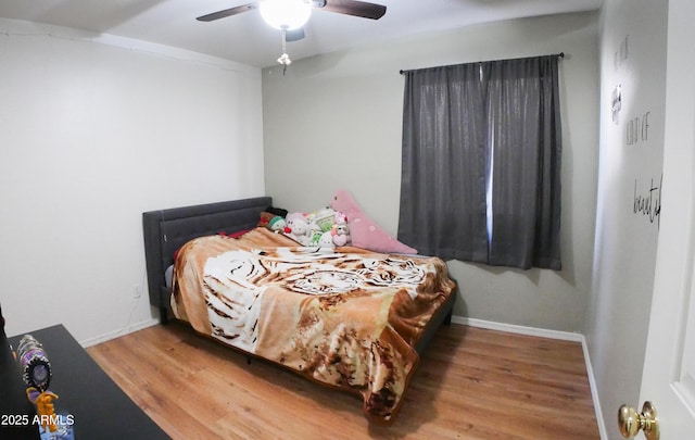 2809 N 107th Dr, Avondale, AZ 85392 - bedroom featuring a ceiling fan, baseboards, and wood finished floors