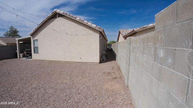 2809 N 107th Dr, Avondale, AZ 85392 - view of side of home with stucco siding, fence, and a patio