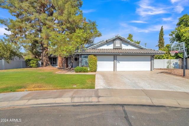 view of front of property featuring a garage and a front lawn