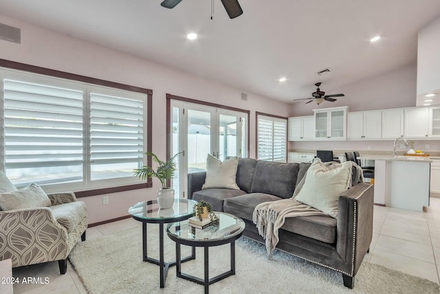 tiled living room with vaulted ceiling, plenty of natural light, ceiling fan, and french doors