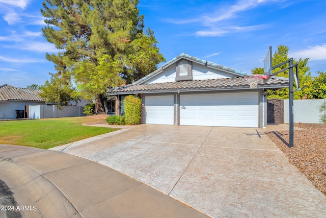 view of front of home with a garage and a front lawn