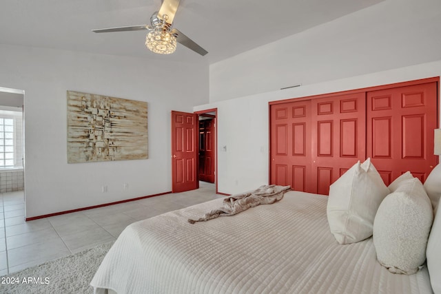 tiled bedroom with ceiling fan and a closet