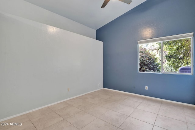 unfurnished room featuring lofted ceiling, ceiling fan, and light tile patterned flooring