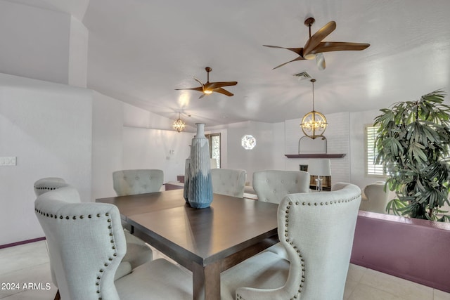 dining area featuring ceiling fan with notable chandelier