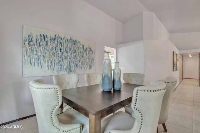 tiled dining area with vaulted ceiling