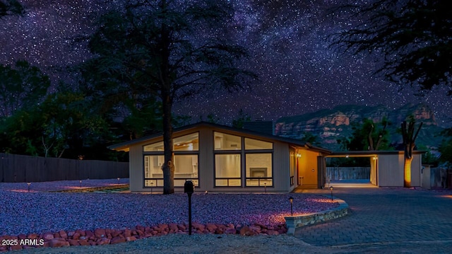 21 Hummingbird Cir, Sedona, AZ 86336 - contemporary house featuring driveway, a sunroom, and an attached carport