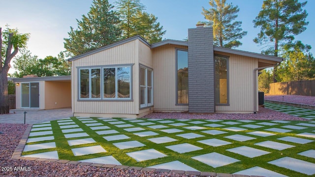 21 Hummingbird Cir, Sedona, AZ 86336 - rear view of house with a chimney and a patio area