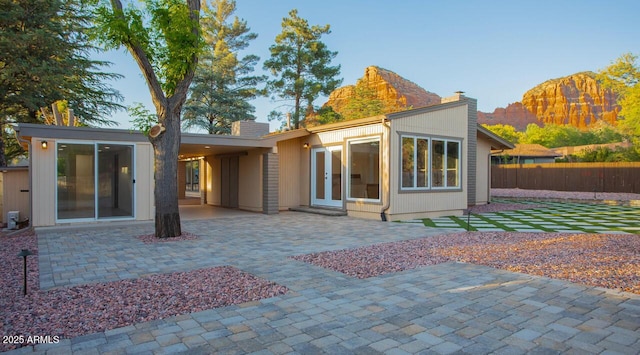 21 Hummingbird Cir, Sedona, AZ 86336 - rear view of house featuring a chimney and a patio