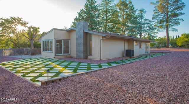 21 Hummingbird Cir, Sedona, AZ 86336 - back of property featuring a chimney, cooling unit, and a patio