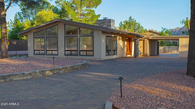 21 Hummingbird Cir, Sedona, AZ 86336 - rear view of house with a chimney