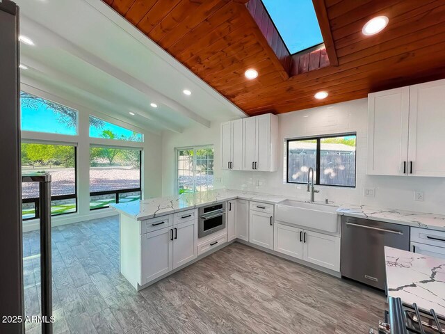 21 Hummingbird Cir, Sedona, AZ 86336 - kitchen featuring a sink, appliances with stainless steel finishes, a peninsula, recessed lighting, and white cabinetry