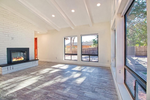 21 Hummingbird Cir, Sedona, AZ 86336 - unfurnished living room with wood finished floors, baseboards, a fireplace, and recessed lighting