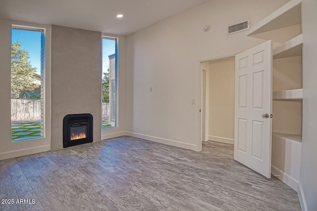 21 Hummingbird Cir, Sedona, AZ 86336 - unfurnished living room featuring wood finished floors, a fireplace, recessed lighting, and baseboards