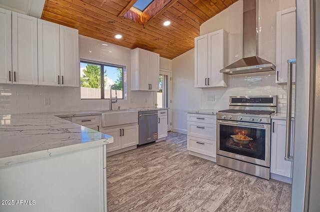 21 Hummingbird Cir, Sedona, AZ 86336 - kitchen with appliances with stainless steel finishes, wall chimney exhaust hood, wood ceiling, a skylight, and a sink