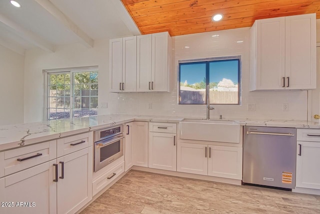21 Hummingbird Cir, Sedona, AZ 86336 - kitchen with stainless steel appliances, a sink, recessed lighting, white cabinets, and light stone counters