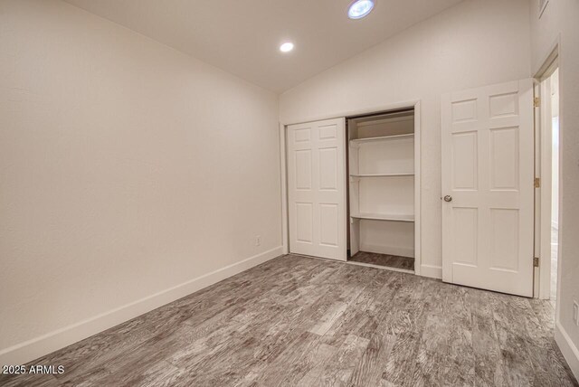 21 Hummingbird Cir, Sedona, AZ 86336 - unfurnished bedroom with wood finished floors, baseboards, recessed lighting, a closet, and high vaulted ceiling