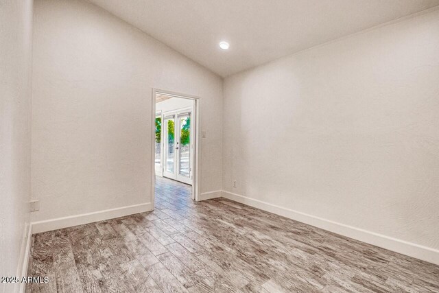 21 Hummingbird Cir, Sedona, AZ 86336 - unfurnished room with wood finished floors, baseboards, lofted ceiling, and recessed lighting
