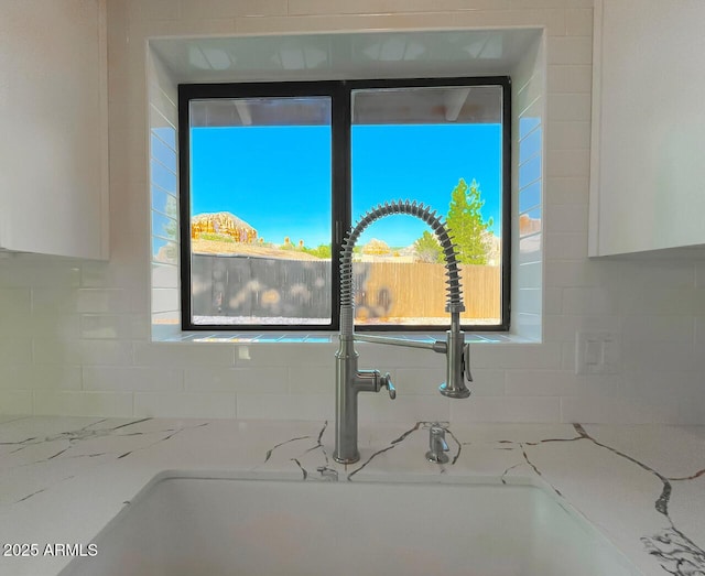 21 Hummingbird Cir, Sedona, AZ 86336 - kitchen view of tasteful backsplash, a sink, white cabinetry, and light stone countertops
