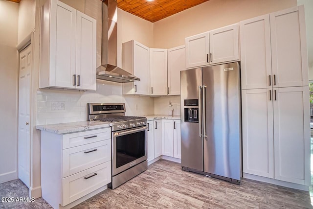 21 Hummingbird Cir, Sedona, AZ 86336 - kitchen featuring stainless steel appliances, wall chimney range hood, wooden ceiling, decorative backsplash, and light stone countertops