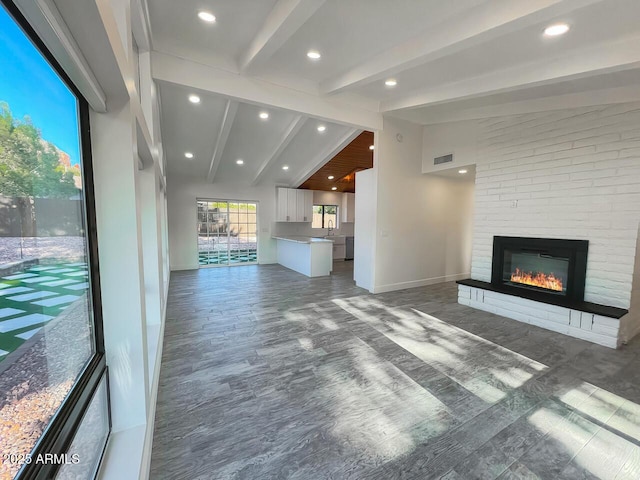 21 Hummingbird Cir, Sedona, AZ 86336 - unfurnished living room featuring a brick fireplace, baseboards, and recessed lighting