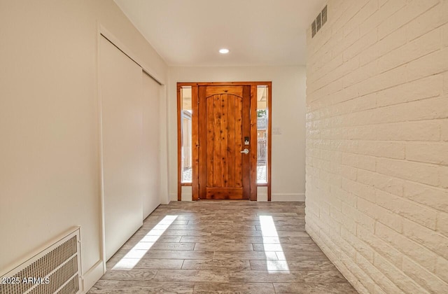 21 Hummingbird Cir, Sedona, AZ 86336 - foyer entrance featuring wood finished floors, brick wall, and recessed lighting
