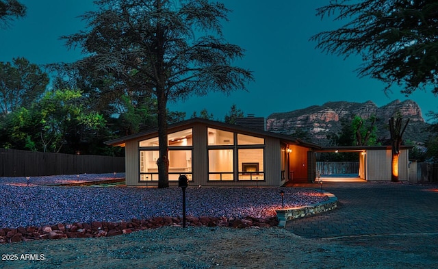 21 Hummingbird Cir, Sedona, AZ 86336 - view of front of property featuring a chimney, a sunroom, a mountain view, and decorative driveway
