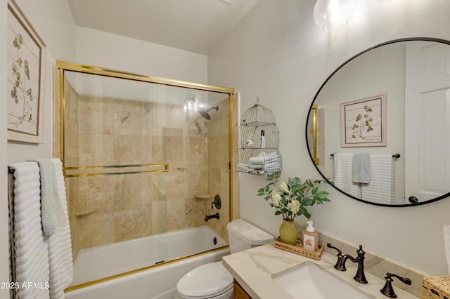 full bathroom featuring enclosed tub / shower combo, vanity, and toilet