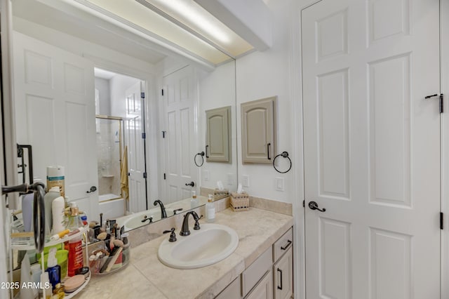 bathroom with vanity and bath / shower combo with glass door