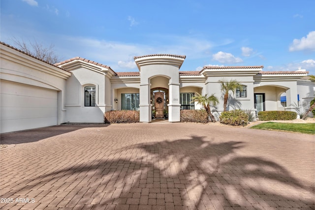 mediterranean / spanish-style house featuring a garage