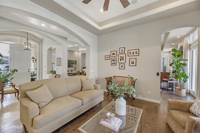 living room featuring dark hardwood / wood-style flooring and ceiling fan