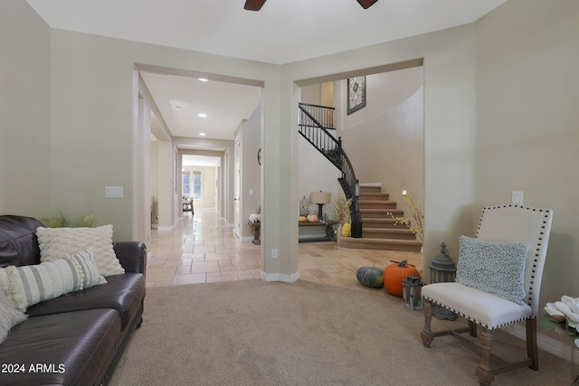 interior space with ceiling fan and light colored carpet