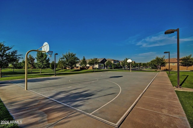 view of sport court with a yard