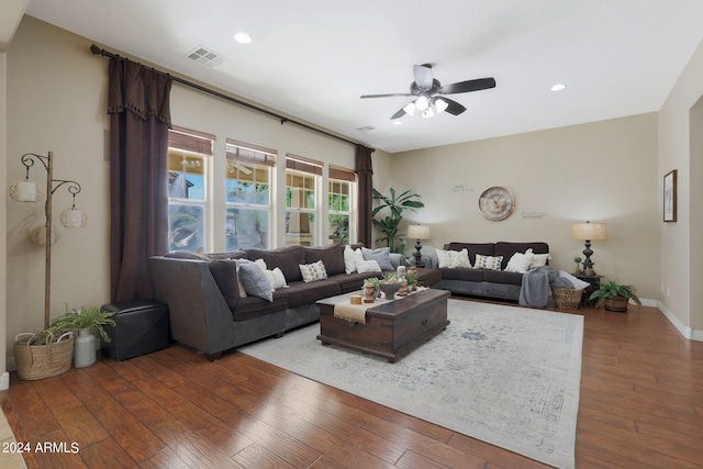 living room with dark hardwood / wood-style floors and ceiling fan