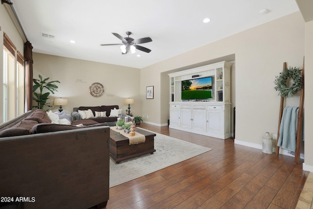 living room with wood-type flooring and ceiling fan